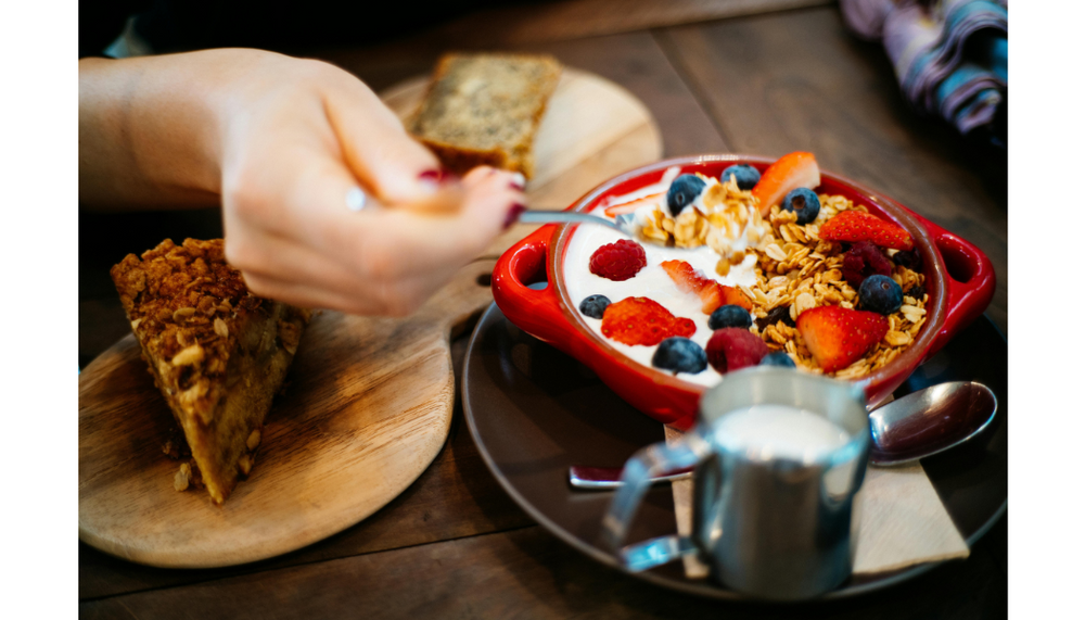 photo de quelqu'un mangeant un yaourt au granola brunch